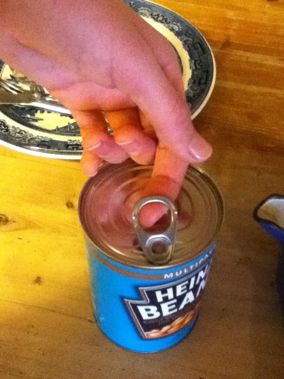 Open your tin of beans by lifting up the ring pull and pulling it open.