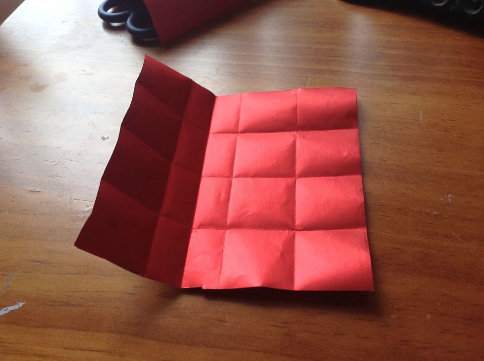 Opening it and it should look like the picture. You are essentially halving the squares you folded before.