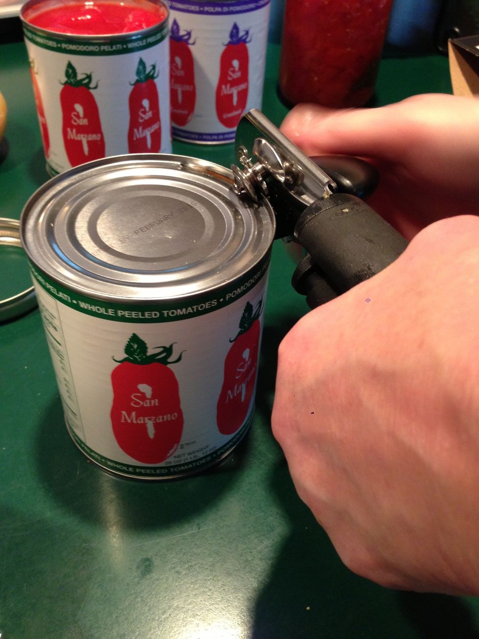 Opening the tomatoes while we wait for the onions to cook