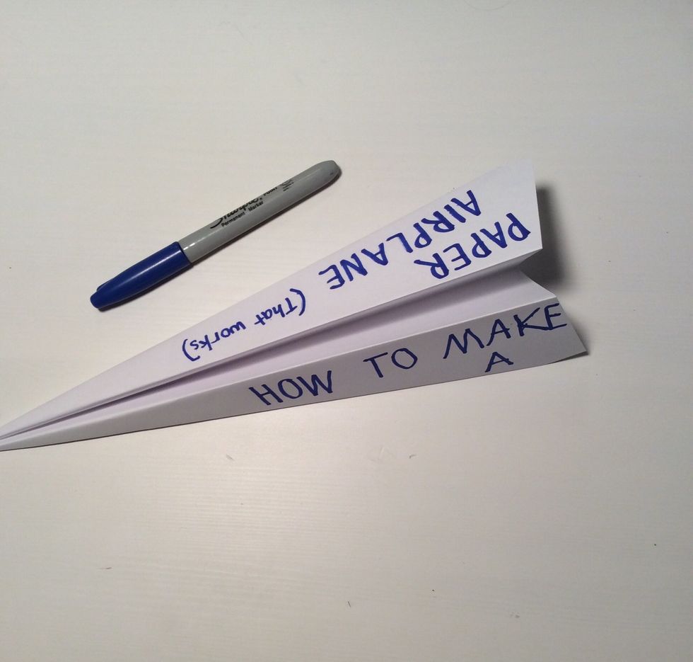 (Optional) Decorate the paper airplane with markers.