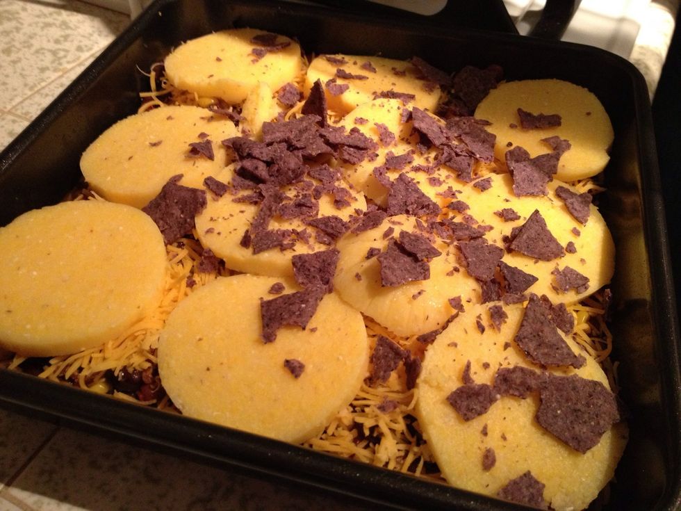 Optional: to add crunchy texture, spread a layer of crushed tortilla chips on top of polenta slices.
