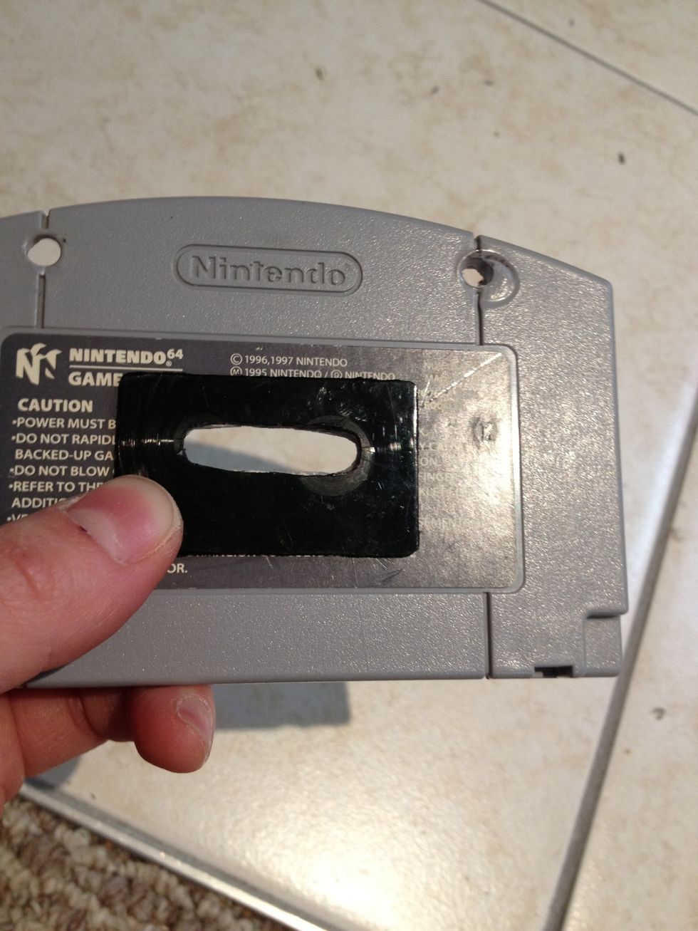 Optional: Using a glue gun, I glued the black plastic onto the front of the N64 game cartridge for some added personality.