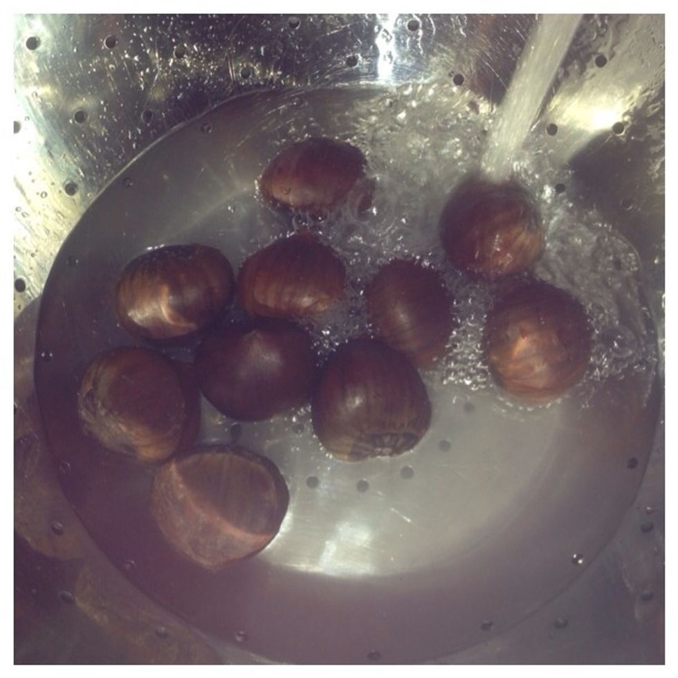 (Optional): Using a stainer rinse chestnuts to be boiled with hot water. This will remove dirt or debris which may get into chestnuts while boiling.