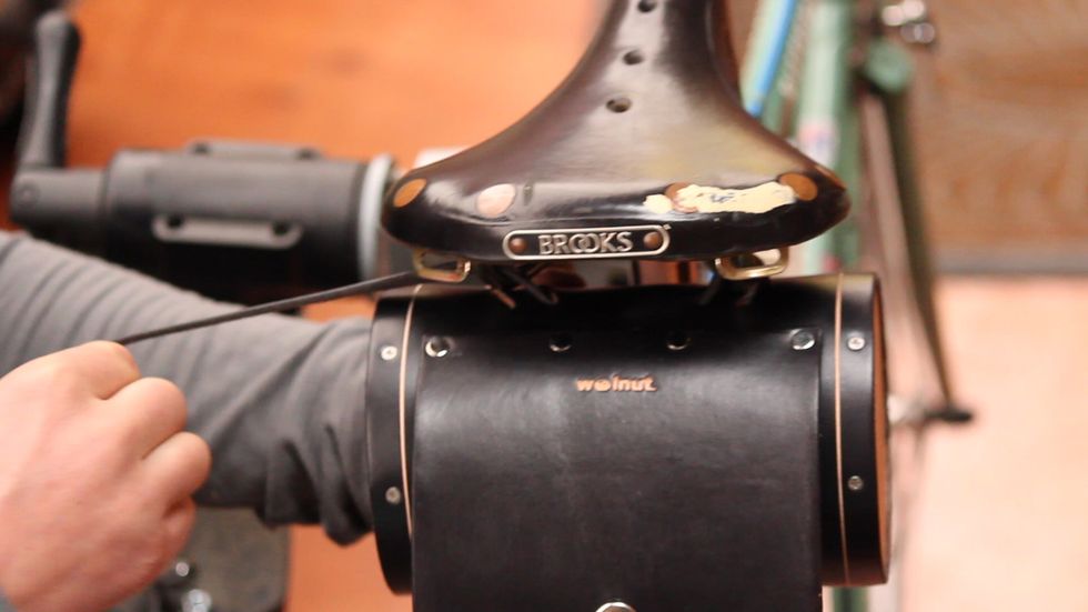 ...or around the left seat rail from the inside out if you're installing on the seat rails.