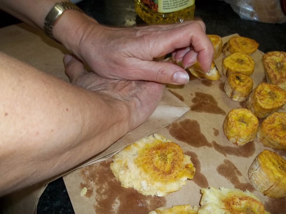 ...or I use a folded brown paper bag and a good "smash" with the palm of my hand. Slide a fork under each tostone to lift from the paper bag.