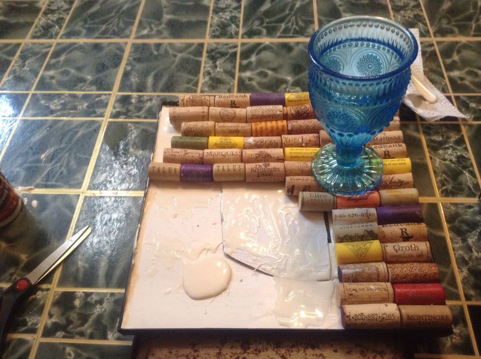 Organize you corks to your liking. The glass is there to put weight on the corks to dry flat.