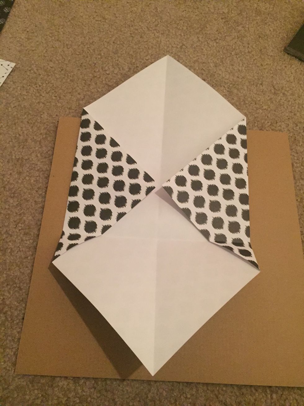 Orient the paper like in the photo. Now we are going to fold the bottom flap up.