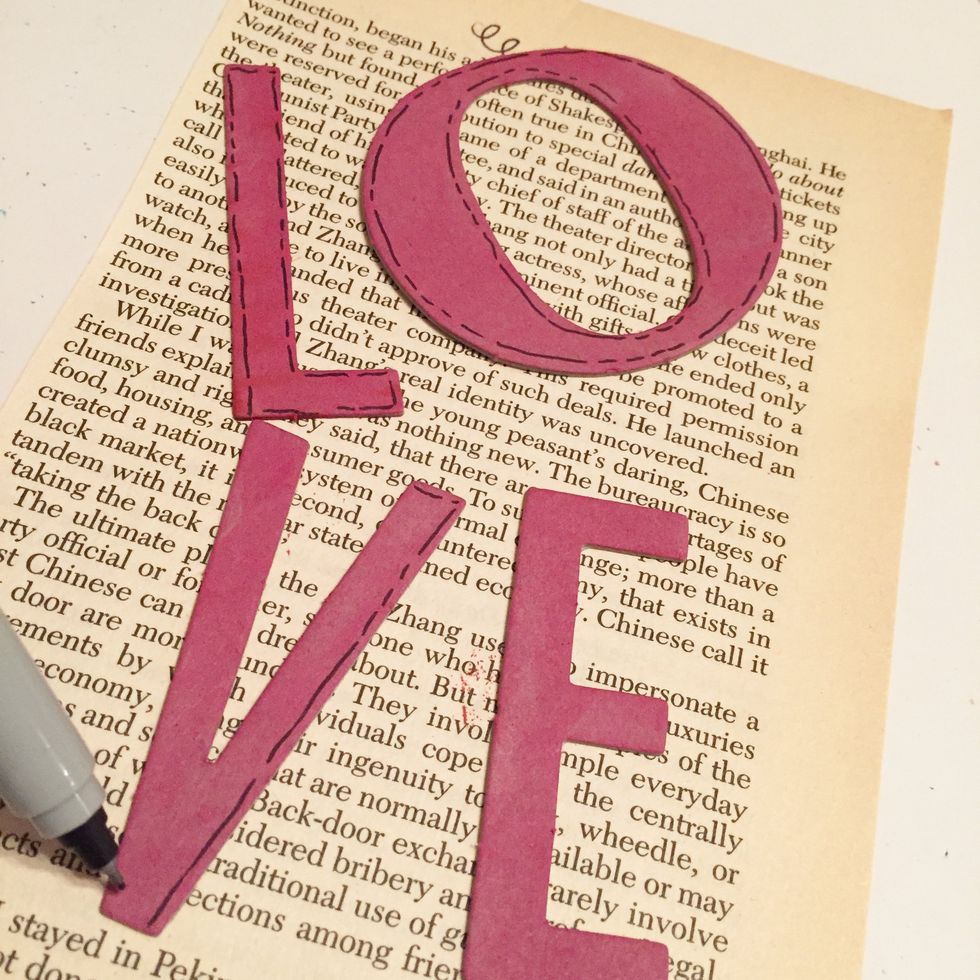 outline letters using black pen.