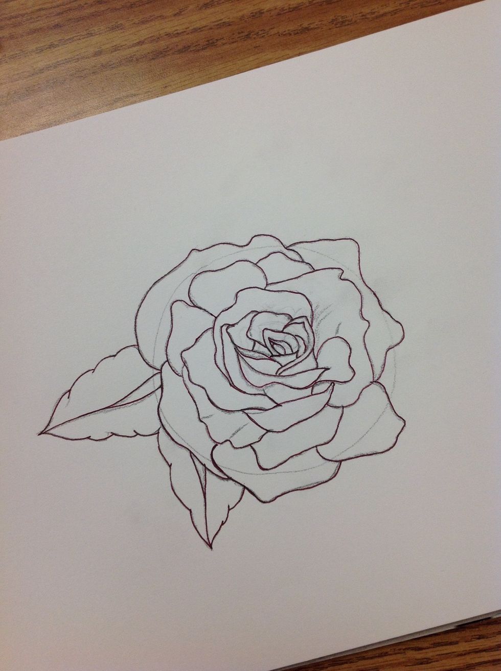 Outline the rose and leaves with the ink pen.