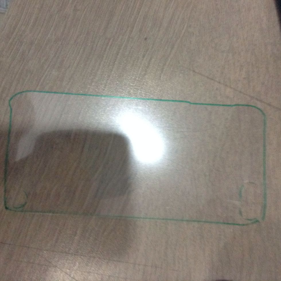Outline your case on an OHP or transparent sheet. Cut it out along with the holes for the camera.