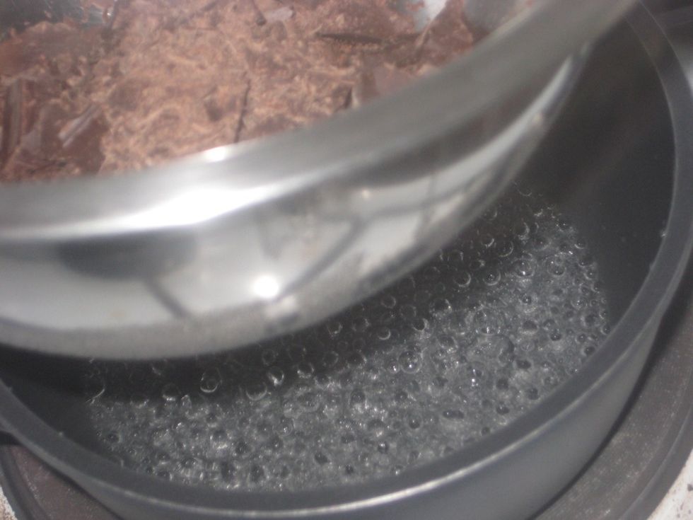 Over simmering water.........