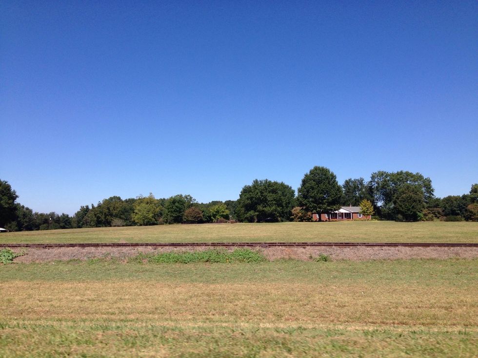 Over the railroad there is the home of someone special! I wonder if they are having family dinner! Pictures hold the story! What do you think is happening within this picture?