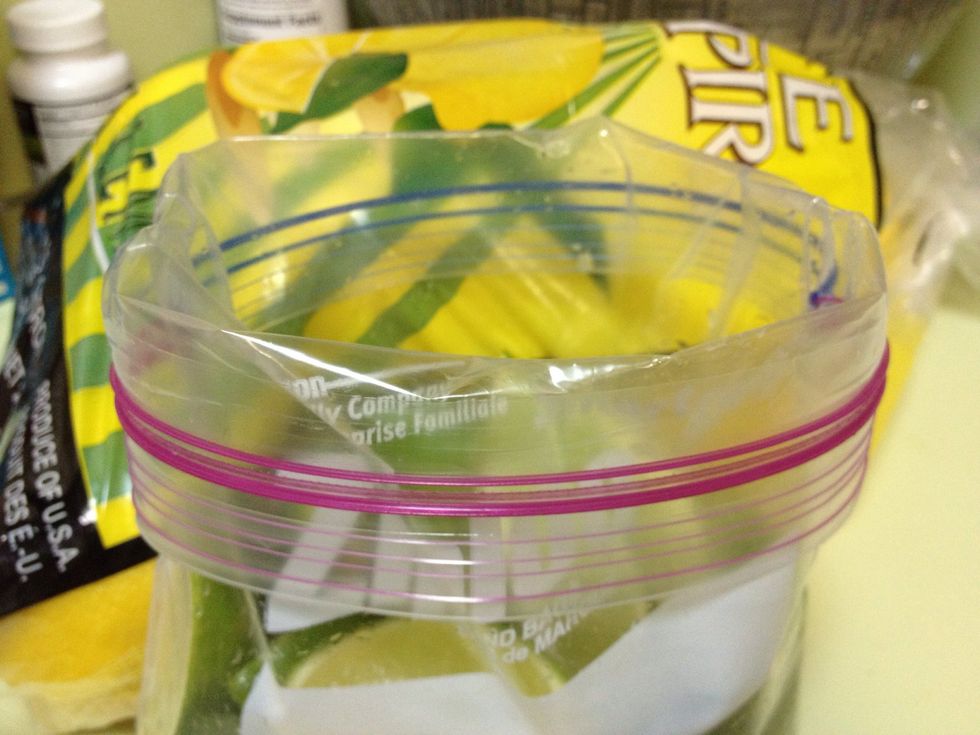 Overturn the top of a 1 Qt. freezer safe plastic bag for easy filling. Make sure the bag is the freezer type, the thick plastic protects the gentle fruit better than the bargain variety.