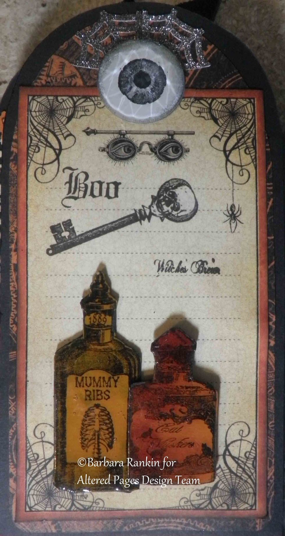 Page 3 right: SCS stamps: potion bottles colored with orange and green & covered with crystal lacquer, fussy cut. SCS stamps: Boo, Witch's Brew, Skeleton Key tamped onto G45 card, Glitz Eye gemstone