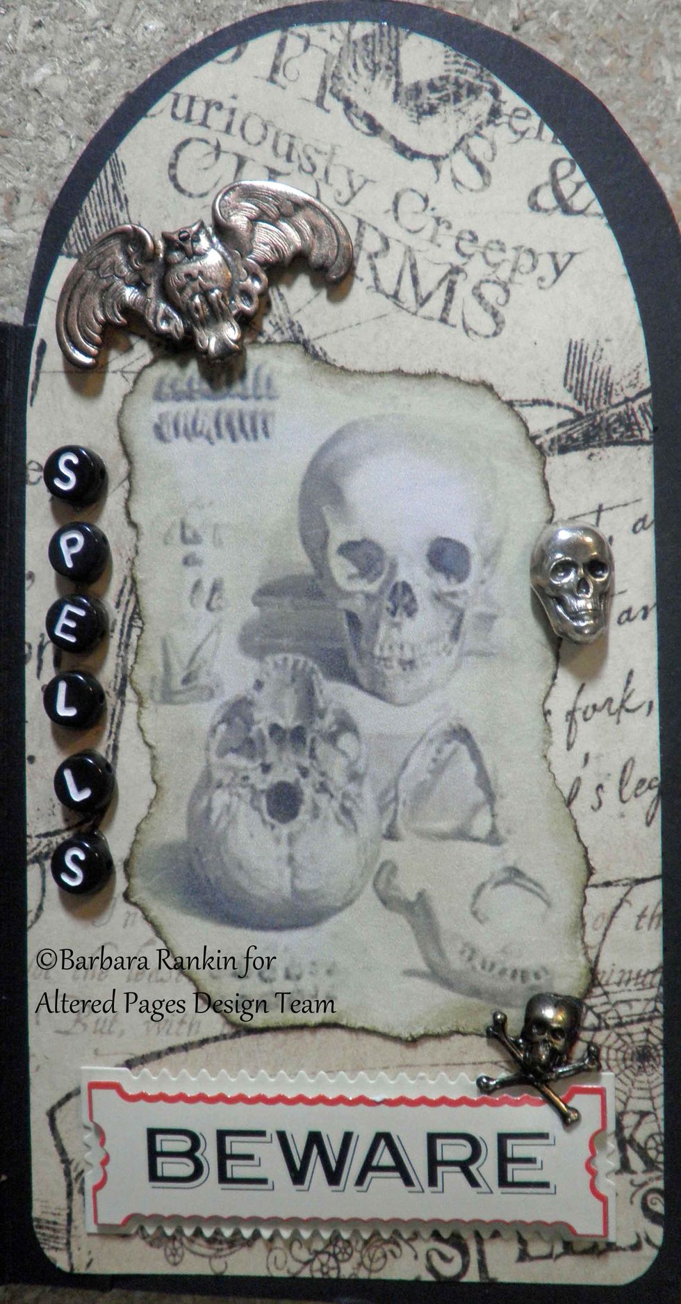 Page 9 right: AP- 2084 Screaming Skulls image torn, inked edges, Beware sticker, metal charms and letters.