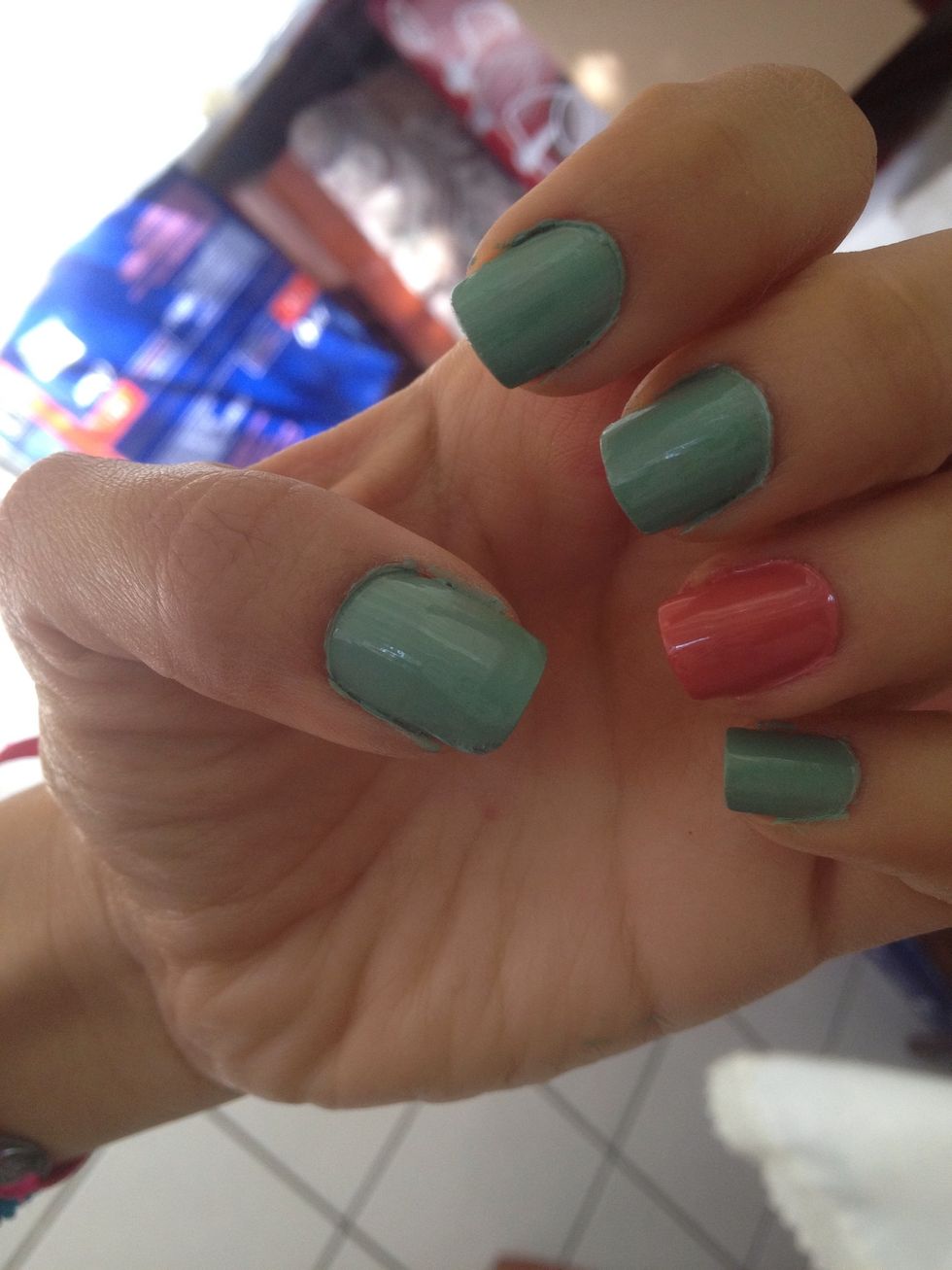 Paint 4 nails with the light Green nail polish and 1 nail with the light pink nail polish.