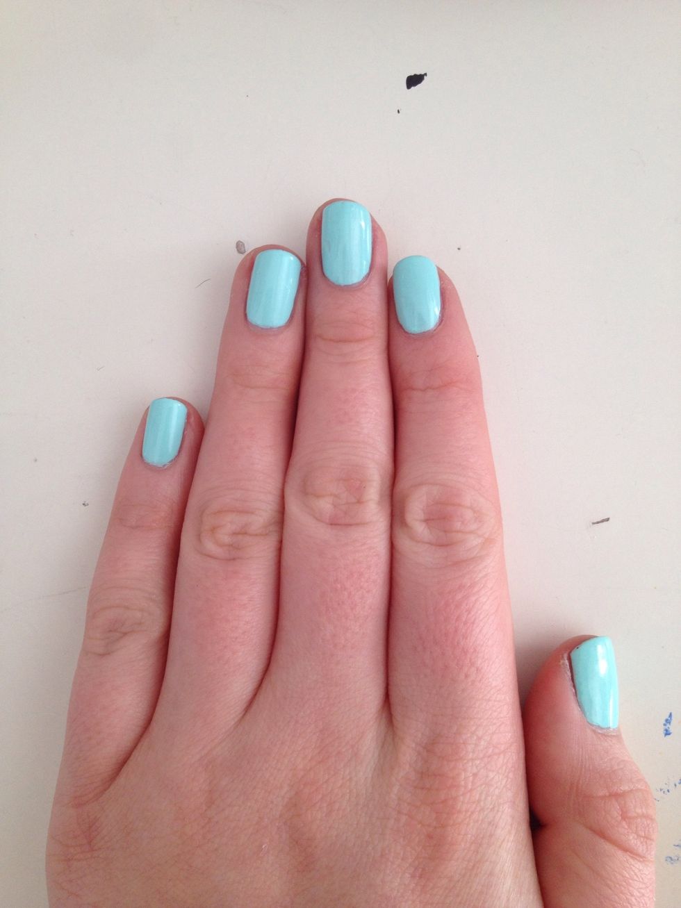 Paint a clear base coat on your nails and then paint your desired base colour onto your nails.