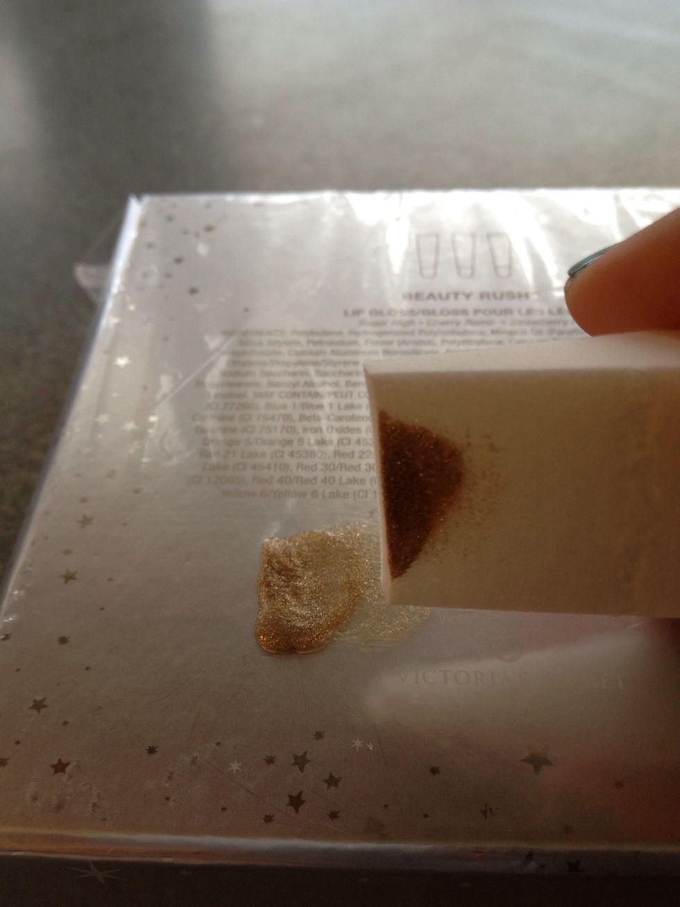 Paint a few drops of your glittery nail polish onto a plastic bag. I put the bag around a box. Then, take your make-up sponge and dip it in the glitter. Dab it once or twice on the plastic.