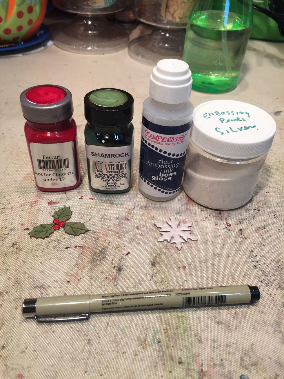 Paint a holly leaf with Shamrock and Ferrari.  Triple emboss a snowflake with silver embossing powder.  Using a Micron pen, add veins to the holly leaves and define the shape of the berries.