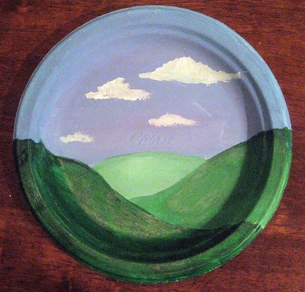 Paint a landscape background on your paper plate, then let it dry. The Tempra paint will dry pretty fast.
