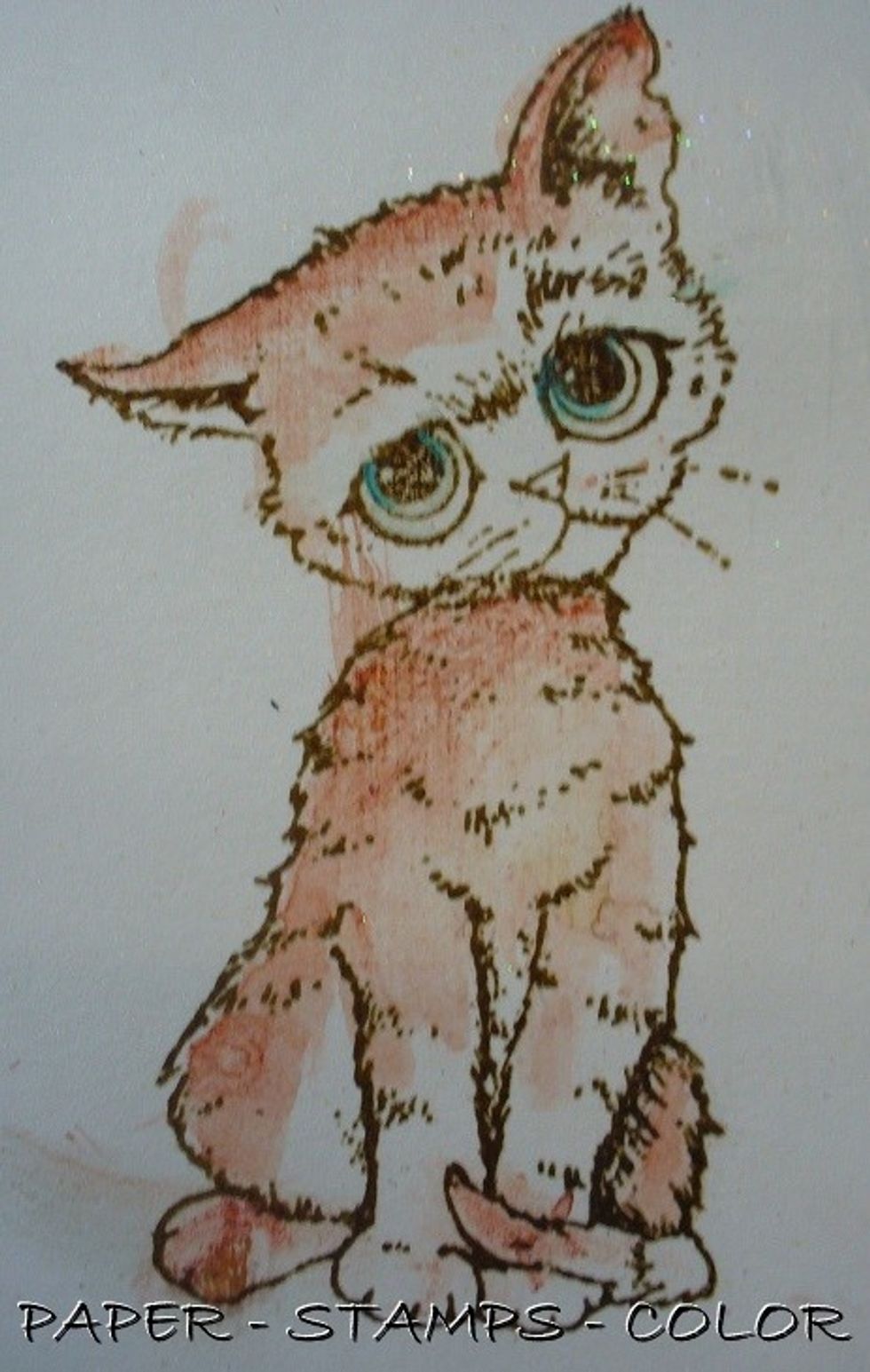 Paint a piece of separate piece of cardstock withFrost Sorbet Clear Coat. Leave to dry. Color the cat with Rustic Colorations Color Spray and Siesta Key Colorations Spray (with a brush). Cut it out.