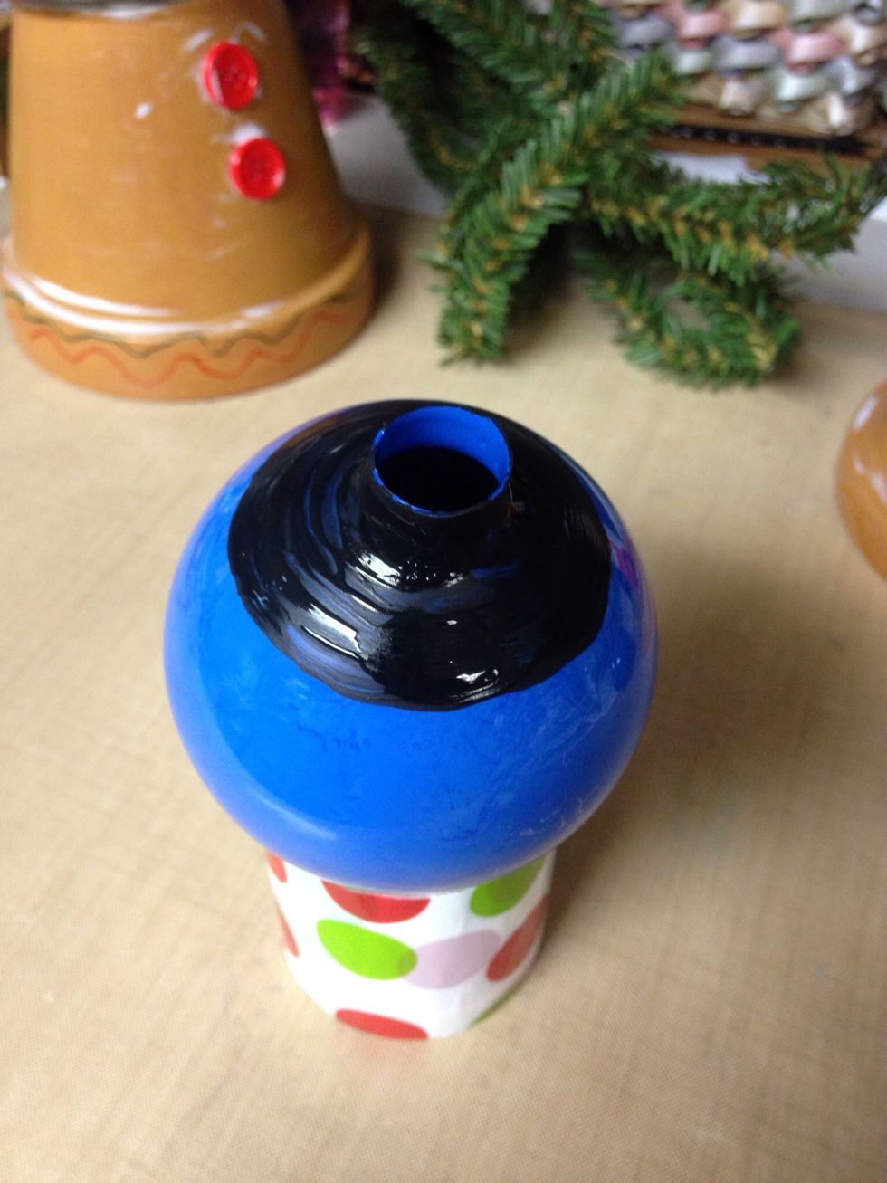 Paint a solid black circle on top of ornament. Let first coat dry, then paint a second coat. I used nail polish on the outside painting. Made a more solid coverage, not easily scratched off.