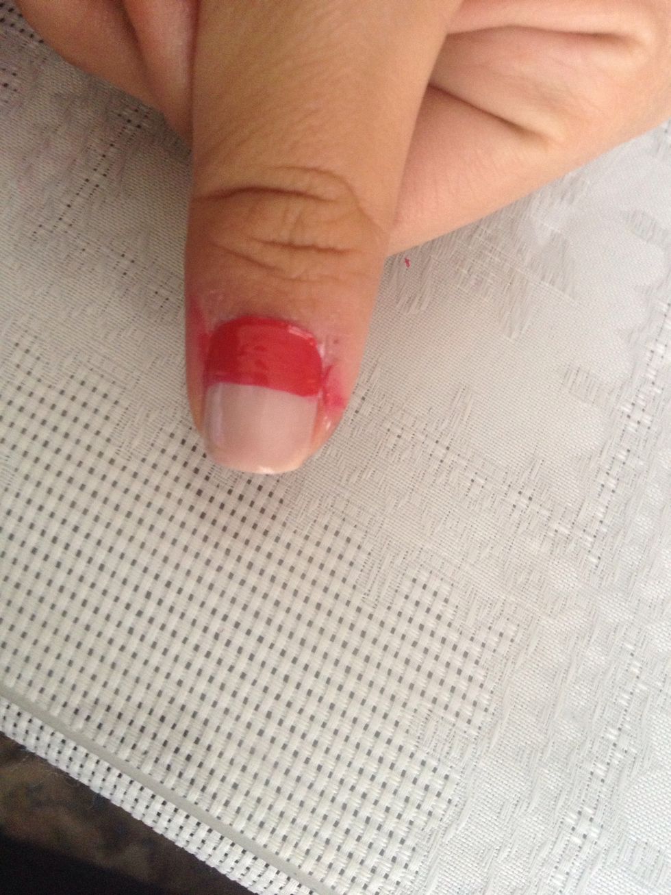 Paint a space with the red nail polish on the last nail without nail polish