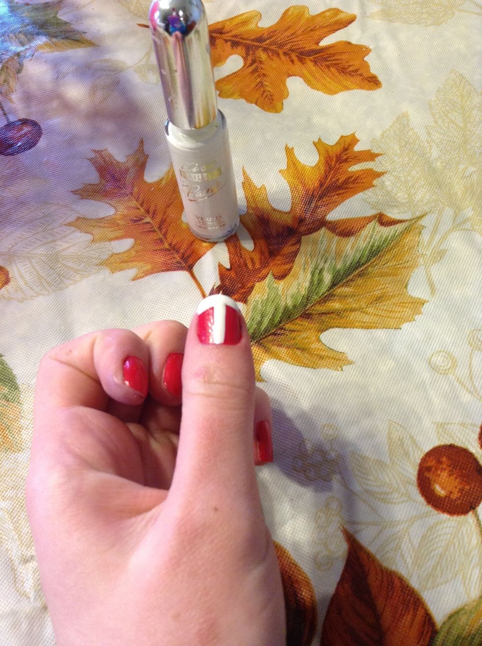 Paint a T with a white nail striper on any finger of your choice! Let dry. ( I would only do one.) \ud83d\udc85