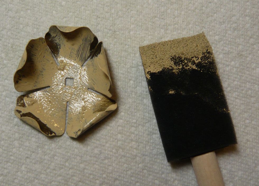 Paint a thin layer of acrylic paint over the metal. Work quickly as you do not want the paint to dry. You may want to allow some of the original metal to show through.