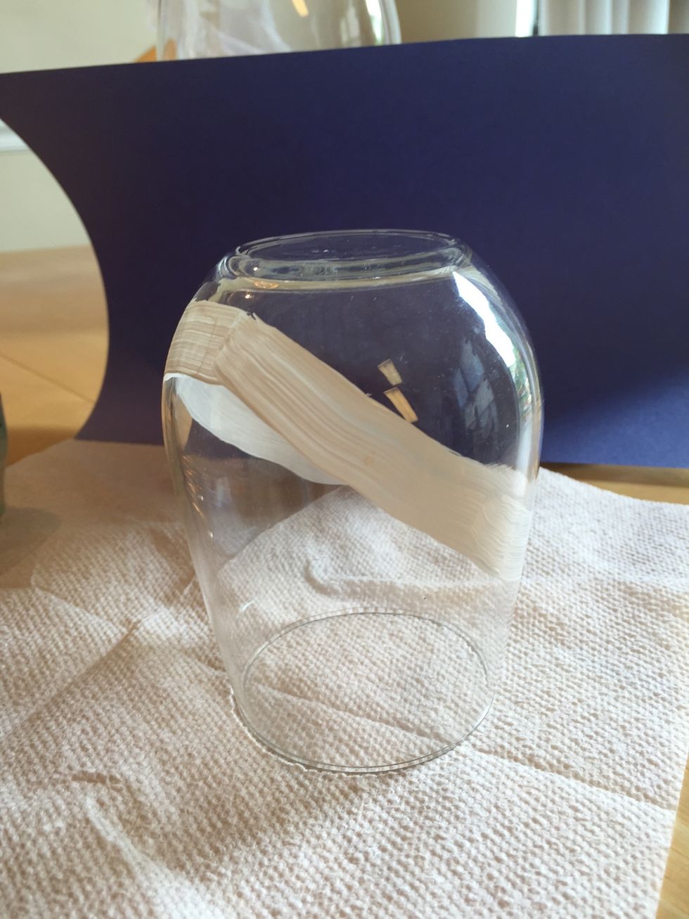 Paint a tipped oval around the glass white.
