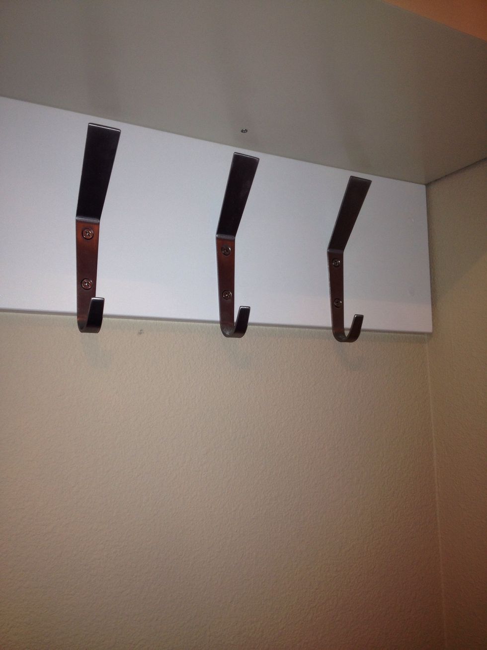 Paint board, mount hooks and hang on wall