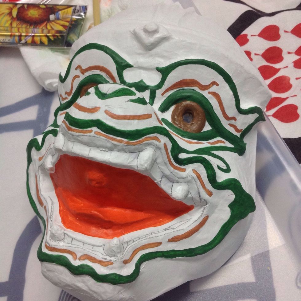 Paint brown eyes and pink facial lines.