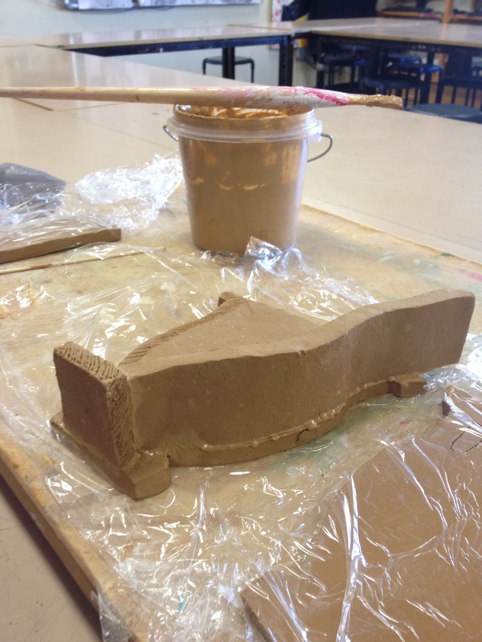 Paint contact surfaces liberally with slurry just before joining each piece. Start with adding the base, then sides. Press each join until slurry begins to escape and a mild vacuum seal is achieved.