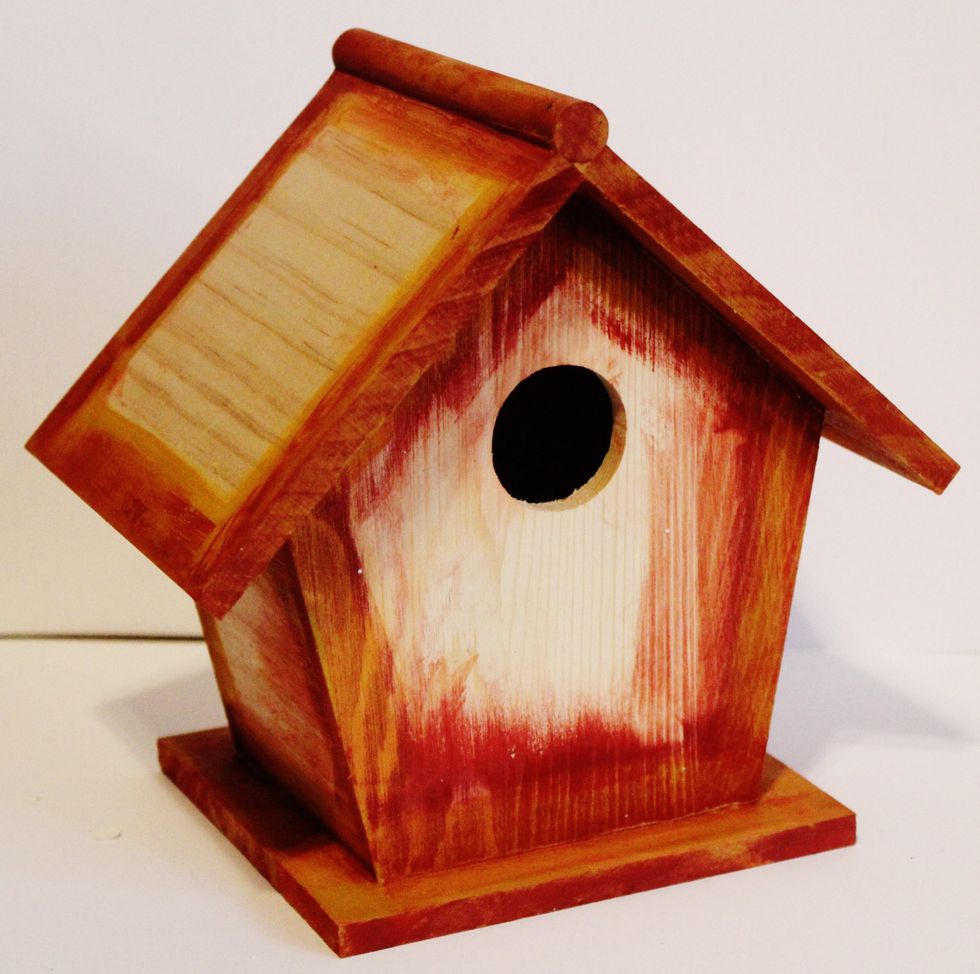 Paint edges and stand of birdhouse with paint with paint brush; dry. Paint over once dry with antiquing cream; dry. Using a damp cloth whip off some of the antiquing cream. Dry completely.