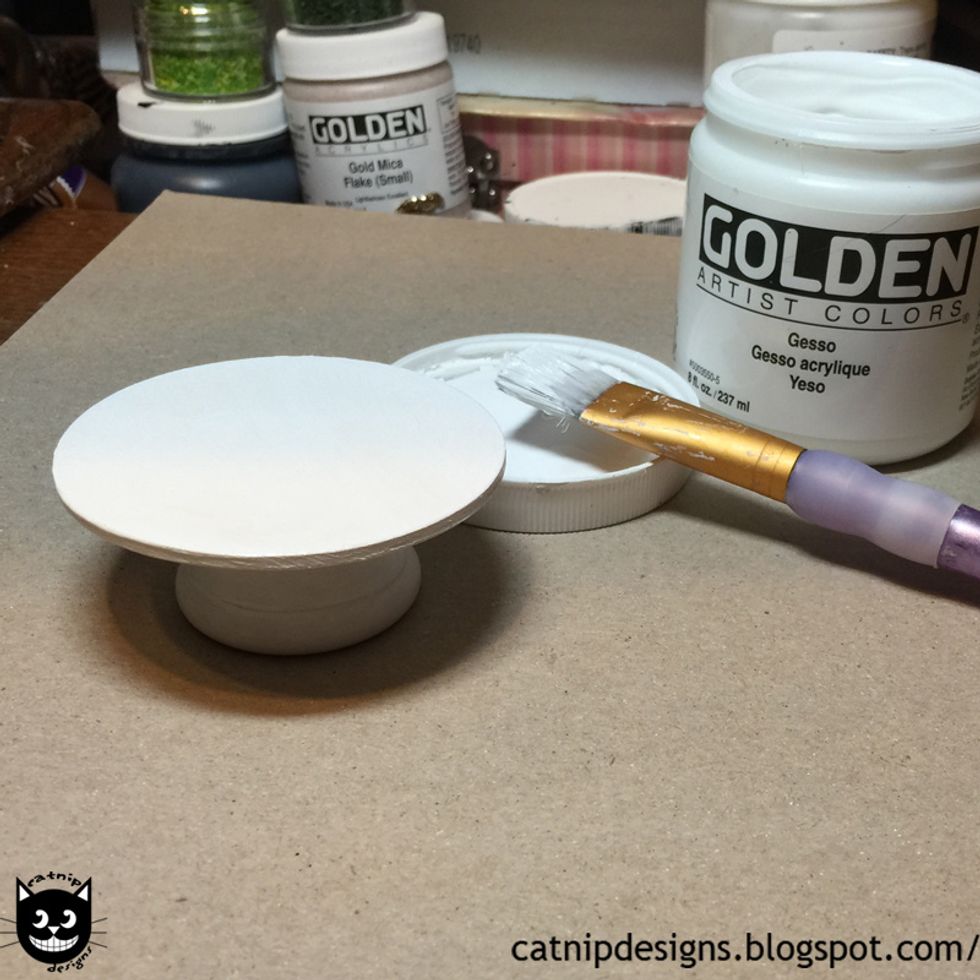 Paint it white with a coat of gesso. (I use gesso because it leaves a nice shabby matte finish.)