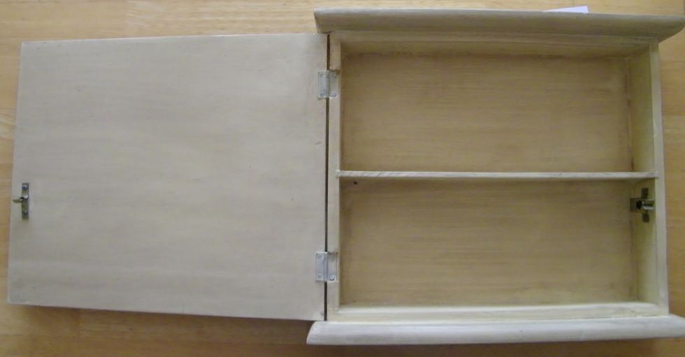 Paint medicine cabinet in white paint and then with black leaving some of the white exposed