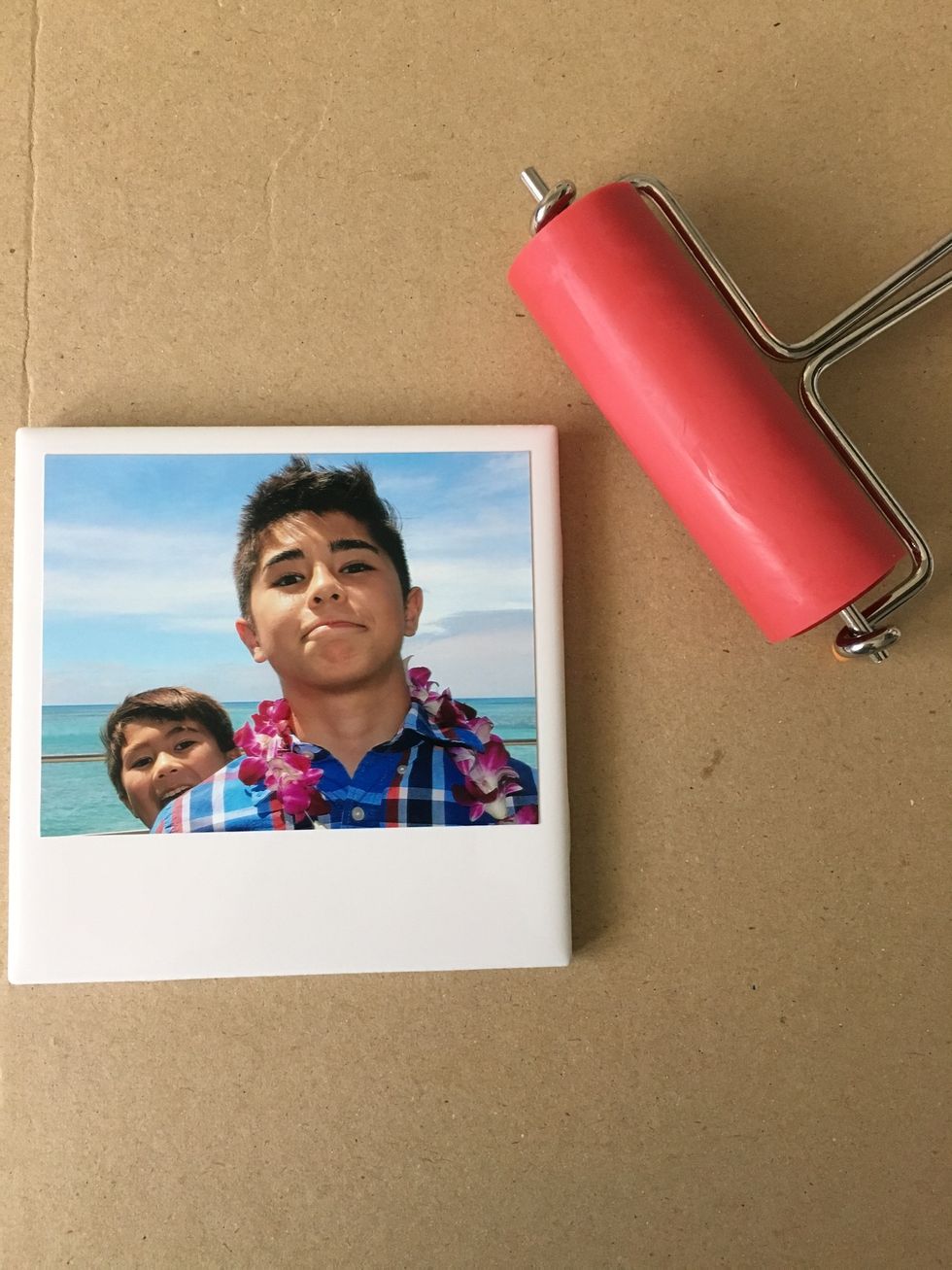 Paint on Mod Podge to the back of the photo with paint brush. Arrange photo from the top and on both sides of tile about 1/4 inch spacing.