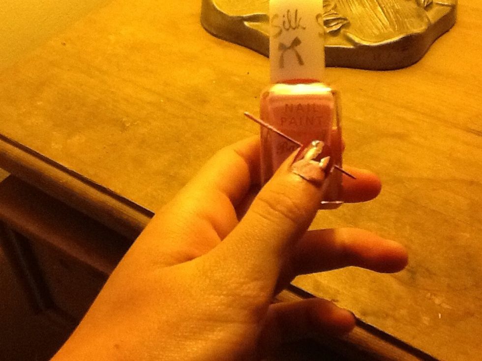 Paint on the bunny's ears by dipping the needle into the pale nail varnish.