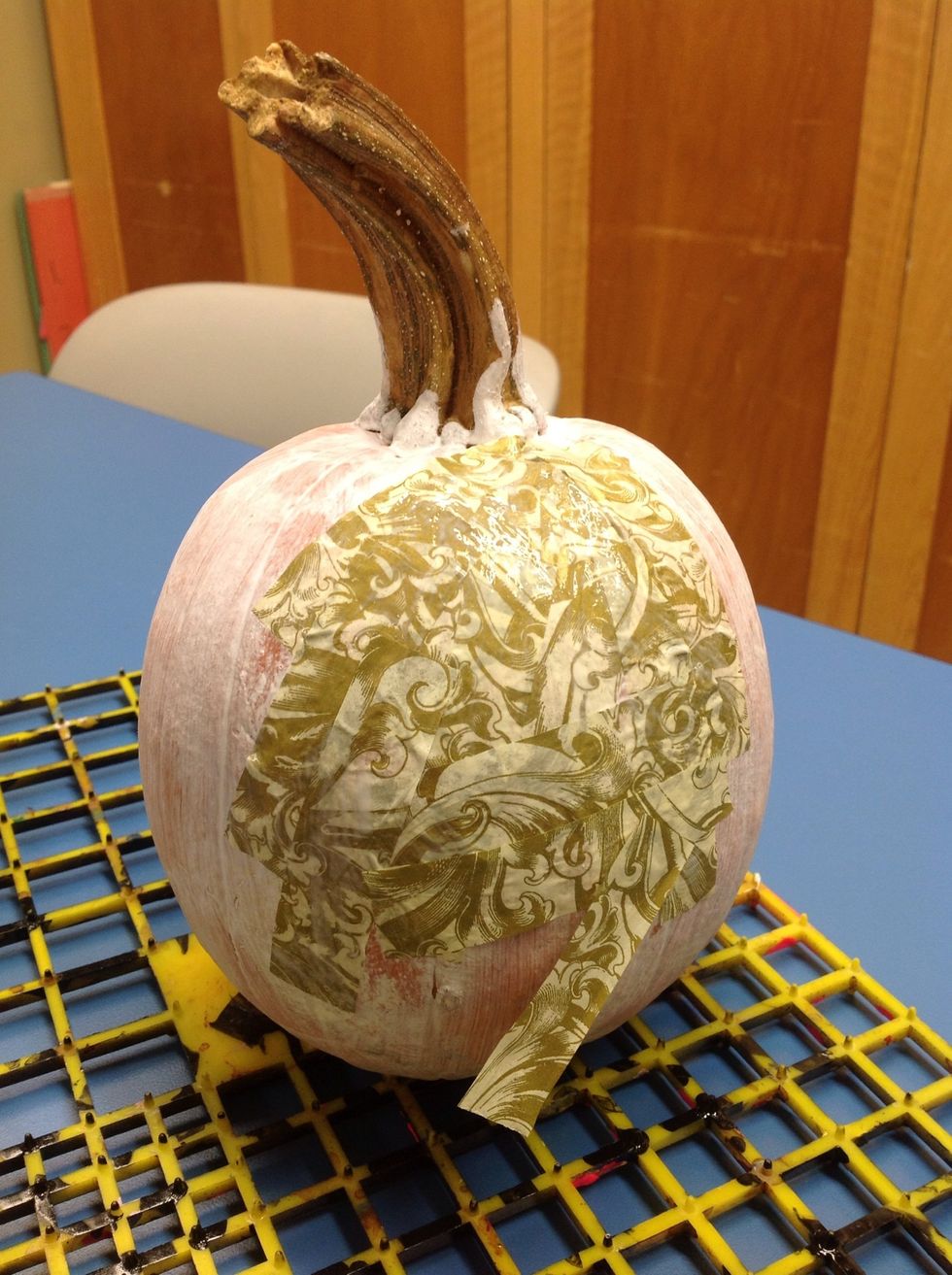 Paint over-glaze on top of the tissue paper to seal all the layers together.  Smooth the tissue with your fingers to bring out the natural  markings/texture of the pumpkin.