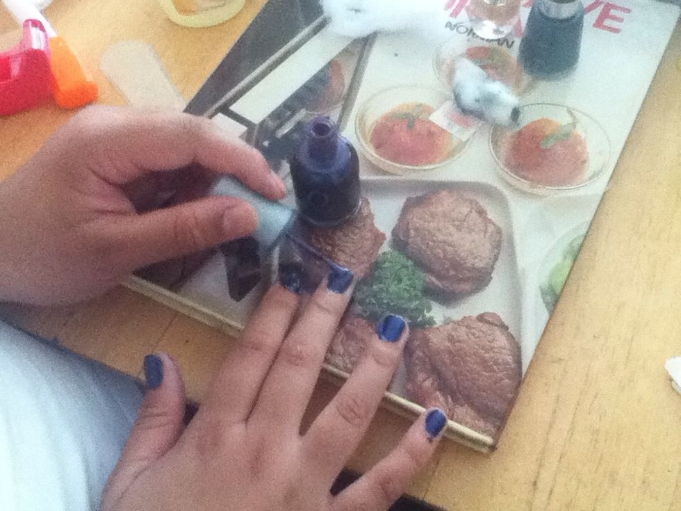 Paint rhe purple nail polish on and the then use the cotton wool to dab it for a crater look