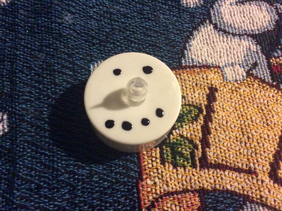 Paint the black nail polish and paint eyes and mouth