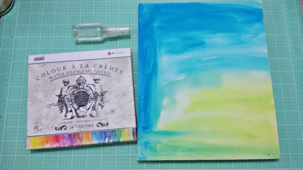 Paint the canvas with water soluble oils pastels with the colors you prefer. I used his fingers to paint and dried with hot heater.