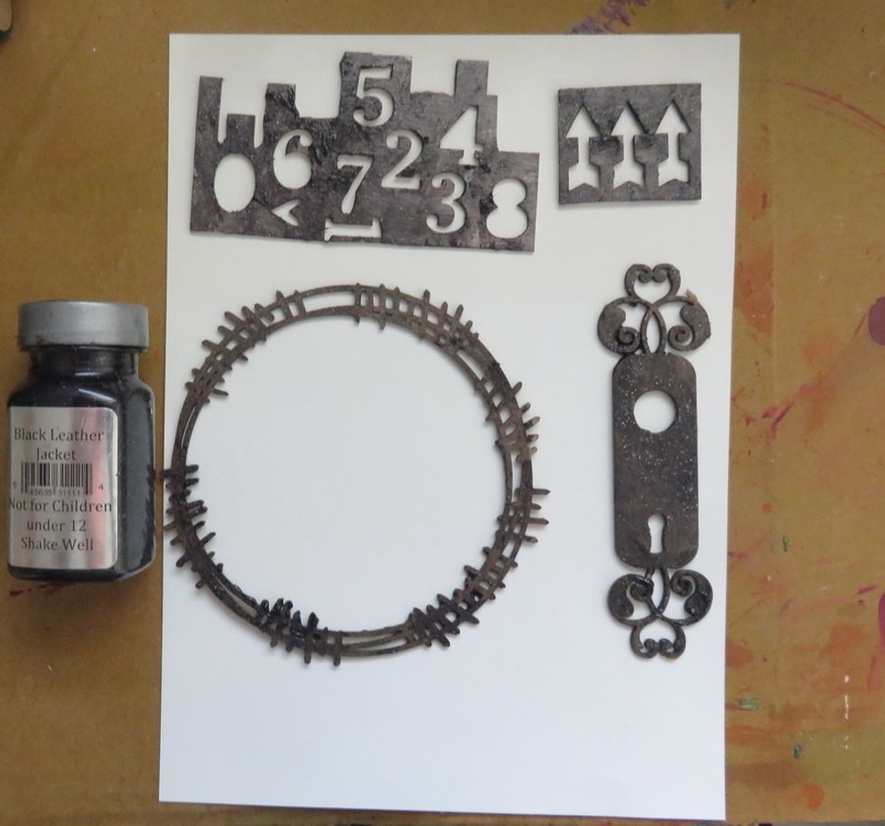 Paint the different chipboard shapes with Black Leather Jacket paint and let them dry.