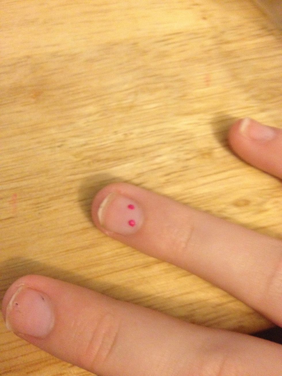Paint the dotter with your nail polish and put two dots at the top of your nail in a diagonal formation.