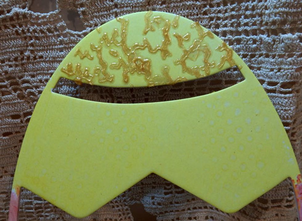 Paint the egg with Lemon Tart Sorbet. Use the Cracked Stencil on the top portion of the egg with Mayan Gold Velvet. Place the Dottie Stencil on the center portion and spritz with Gold Colorations.