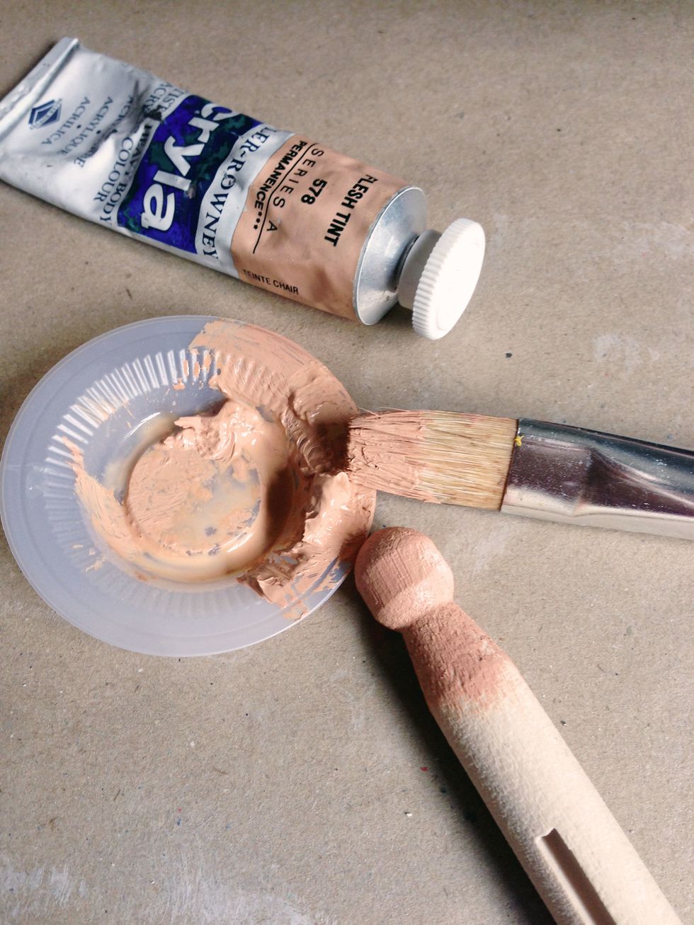 Paint the entire dolly peg using flesh tint paint... If you want a fairer look, you can leave it unpainted...