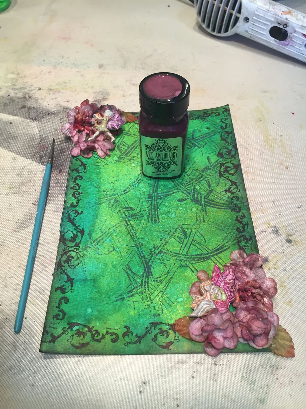 Paint the flourishes with Wineberry Velvet.  Mix a little water in a bit of Wineberry Velvet and flick across page with a paintbrush.