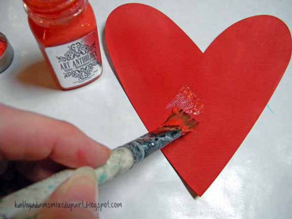 Paint the large heart with Coral Sorbet and let that dry, added stamping using Vermillian ink and attached it to the background using matte medium.