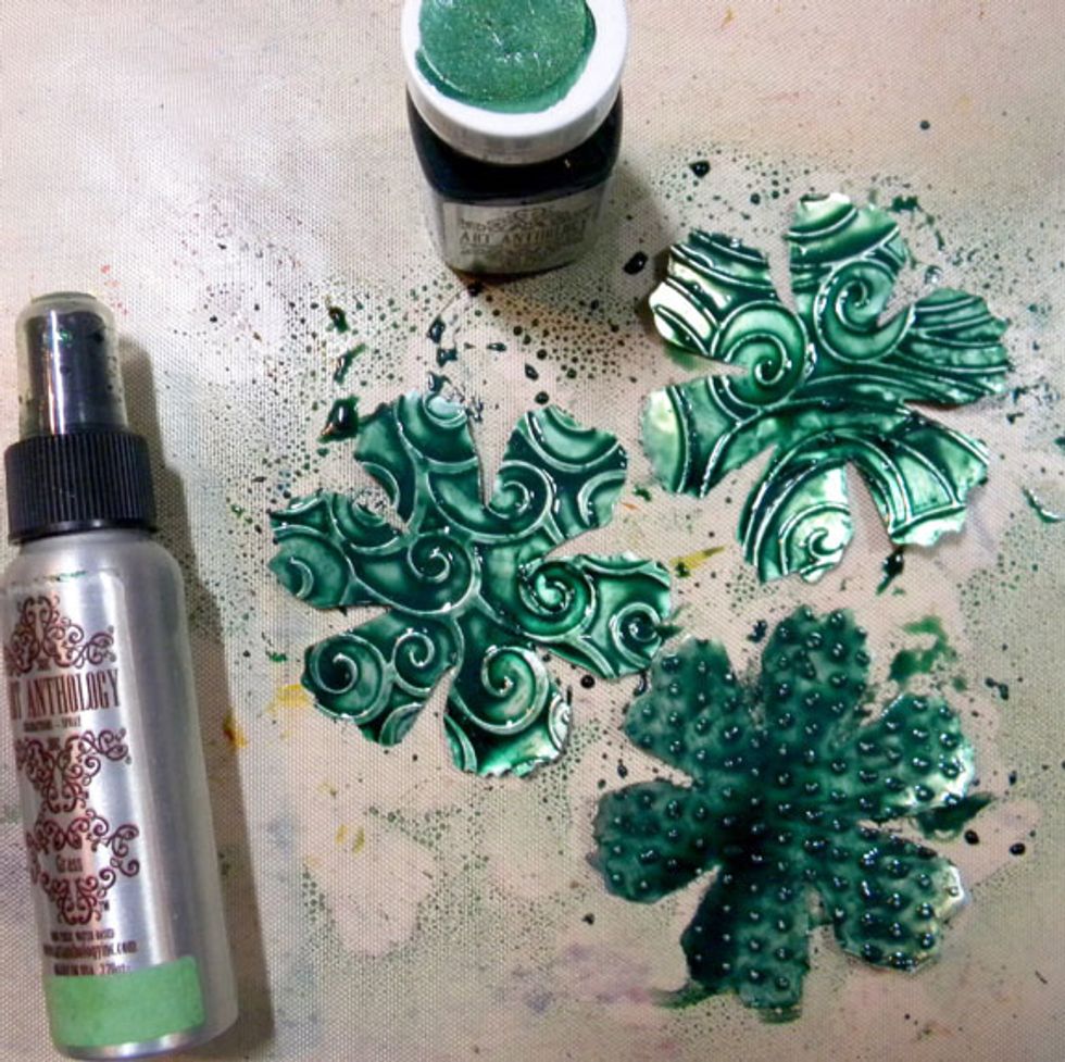 Paint the largest flower with Emerald Gemstones. While they are wet, spray with Grass Colorations Spray and set aside to dry. This allows the color to pool around the embossed areas nicely.