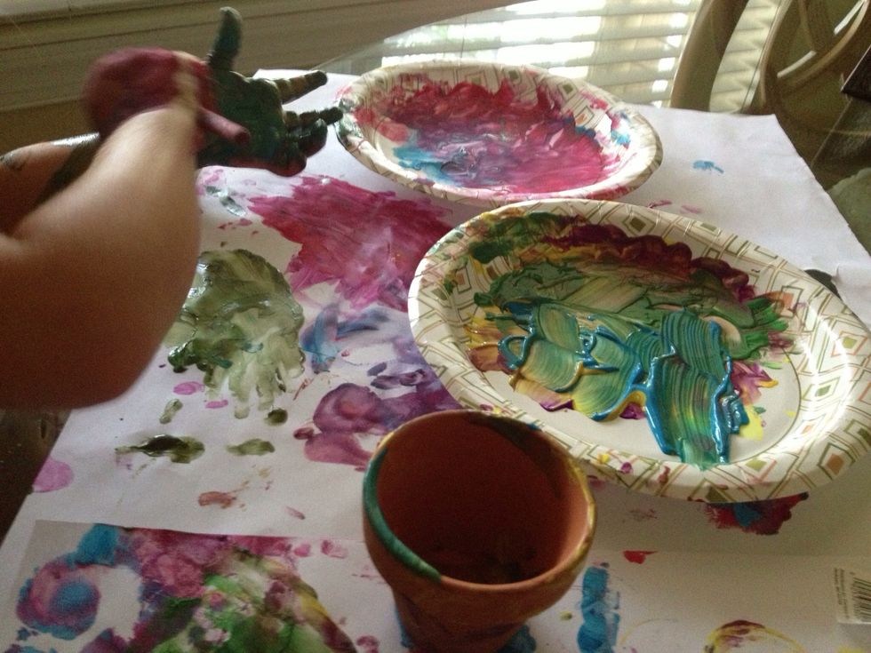 Paint the paper with fingers and/or brush. This is very messy so either have the child wear a painting apron or go al naturale! Paint palm of the child's hand or dip it in the paint.